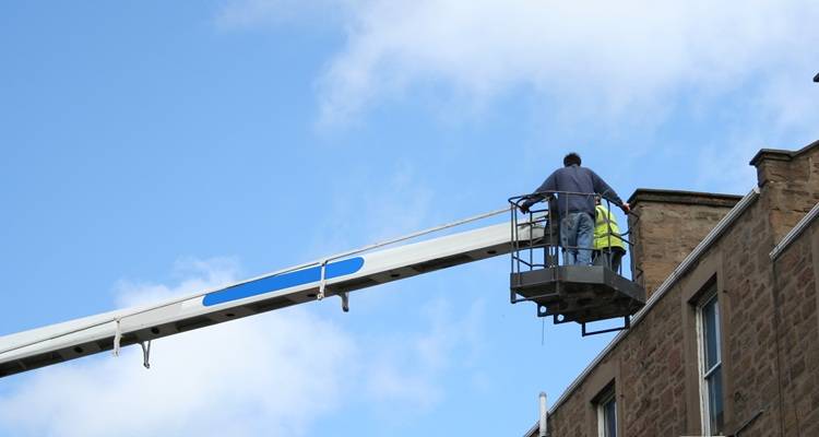 Man cherry picker and roof