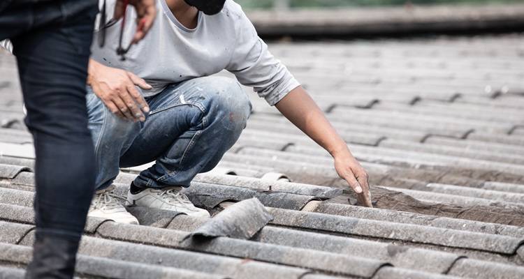 Men looking at roof tiles
