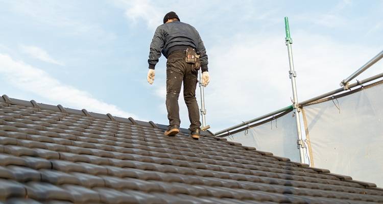 Man walking up roof