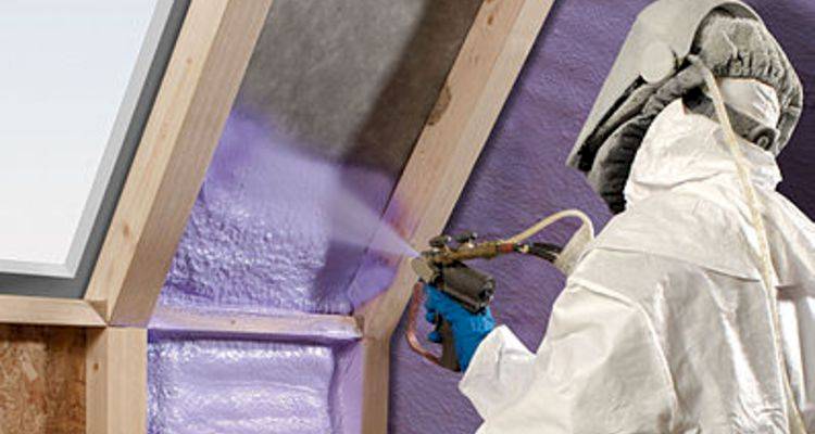 roof insulation cost guide &mdash; expanding foam insulation being applied by a specialist