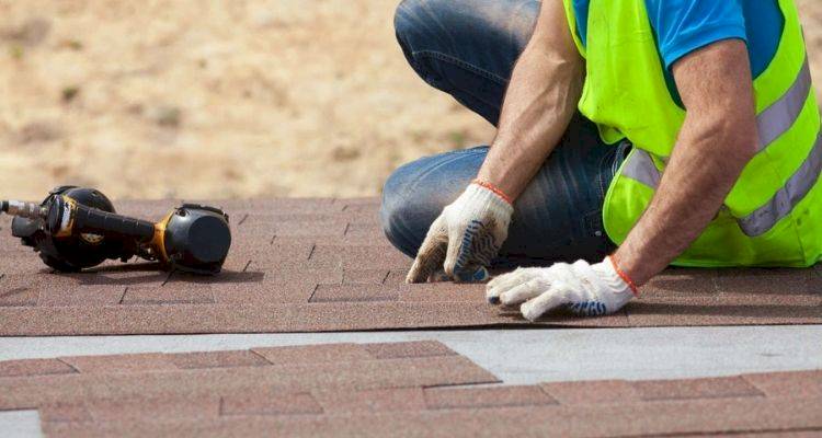 roofer preparing replacement tiling materials for a repair job