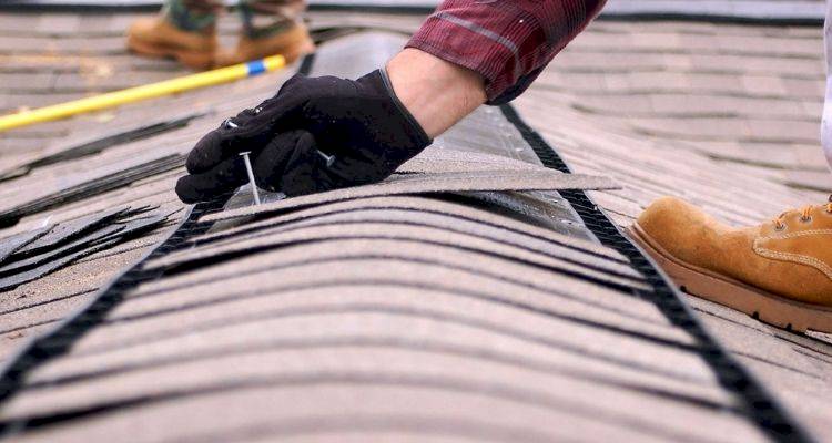 roofer repairing a roof in the UK