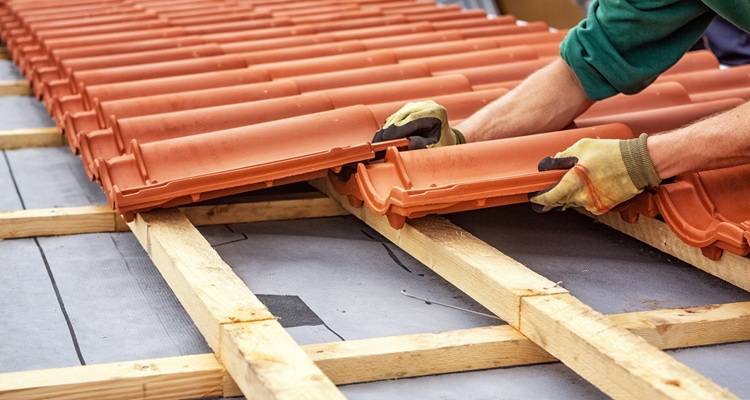 roofer installing roof tiles