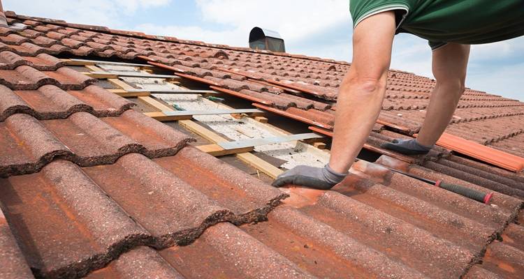 roofer installing roof tiles