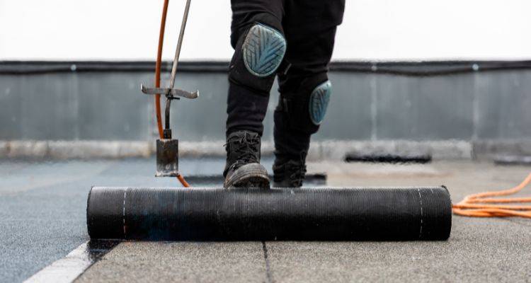 unrolling rubber roofing