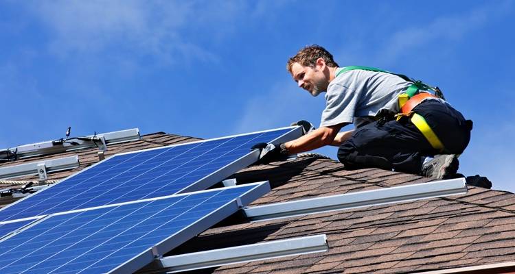 man fitting panels roof