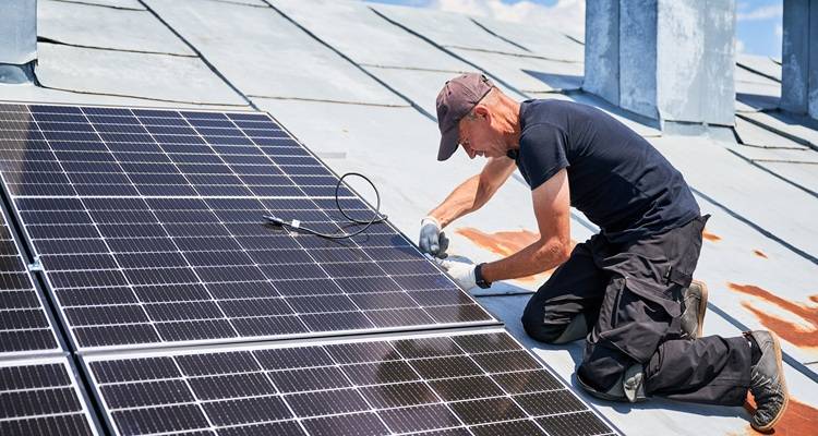 man wiring solar panels