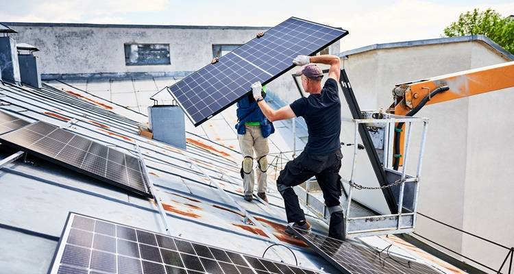 cherry picker workers solar panels