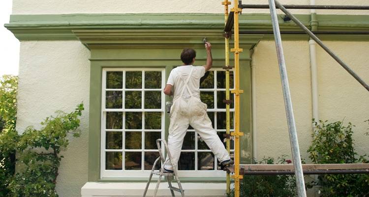 Man painting house exterior