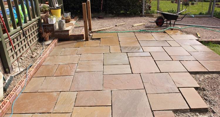 Half a patio being laid