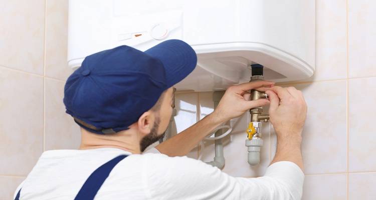 man installing water heater