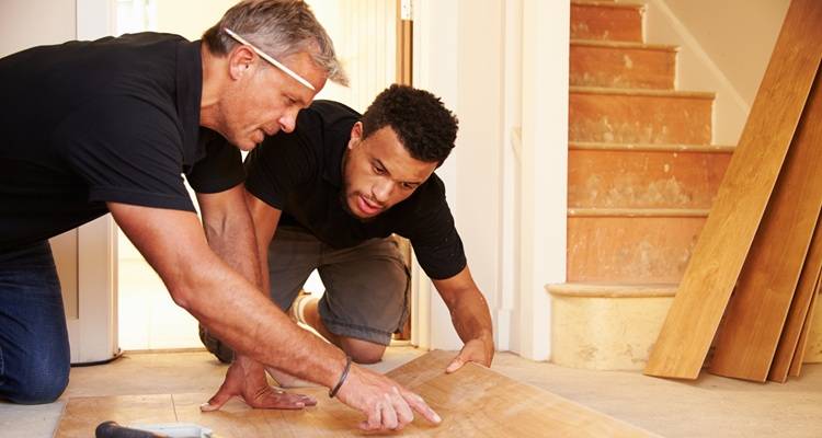 Men laying flooring