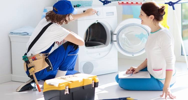 couple in front of tumble drier