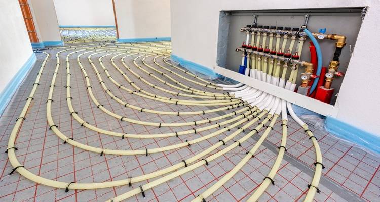 wet underfloor heating feeding into pipes