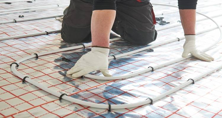 water underfloor heating pipes being laid