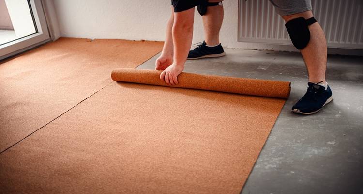 cork underlay being laid man red t shirt