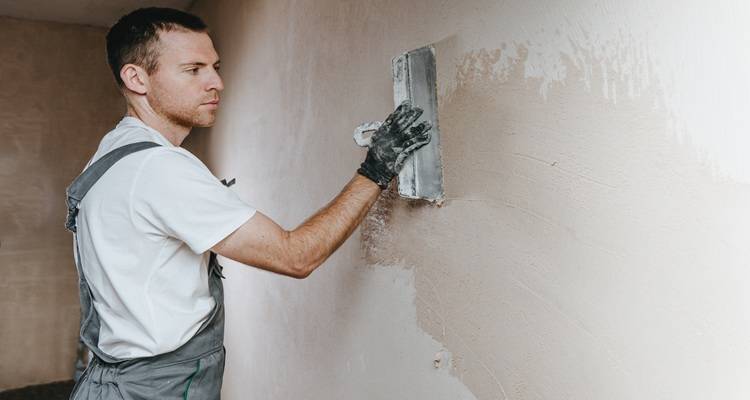 man plastering wall side on photo