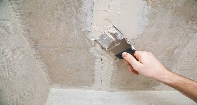 hand filling cracks over tape