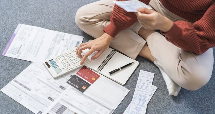 woman sat with bills