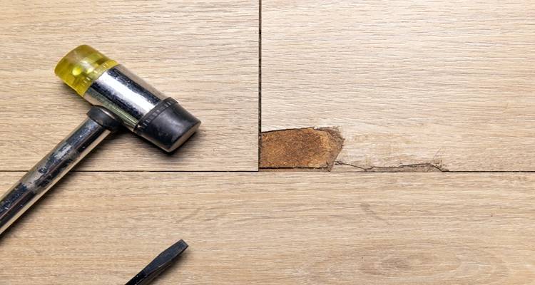 water damaged laminate and hammer