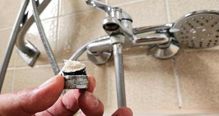 limescale covered end of tap